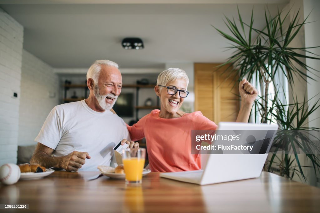 Senior couple bidding on an online auction