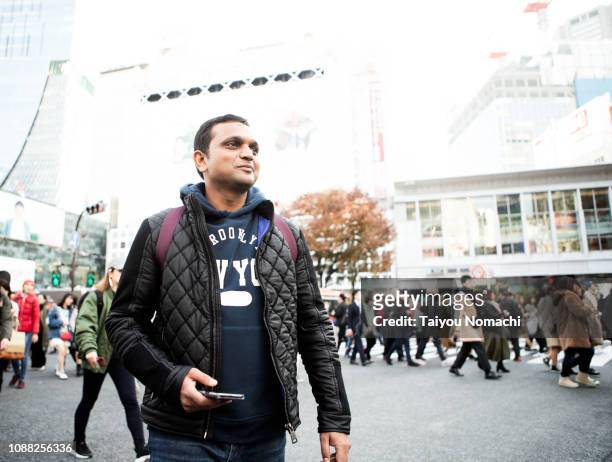 indian tourist who came to the shibuya scramble intersection - looking around stock pictures, royalty-free photos & images