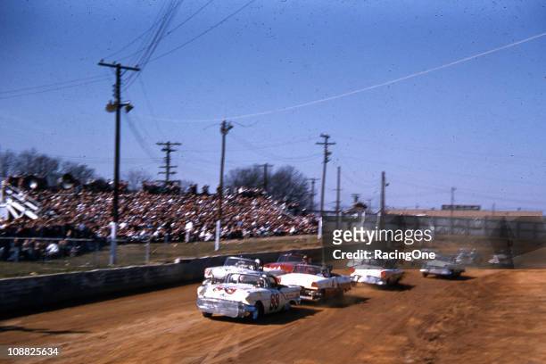 Bill Lutz , driving an Oldsmobile for Petty Enterprises, leads the pack during a NASCAR Convertible Series race at Greensboro Fairgrounds.