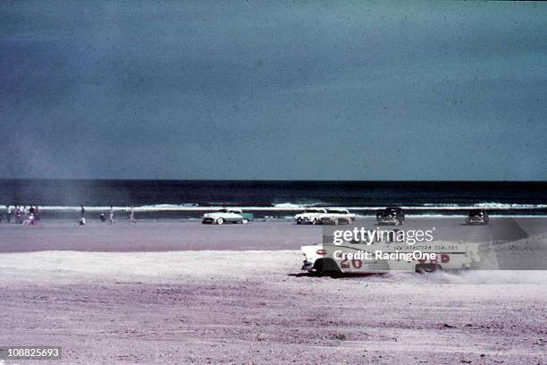 Curtis Turner kicks up some sand on his way to winning the NASCAR Convertible Series race at the Daytona Beach-Road Course.