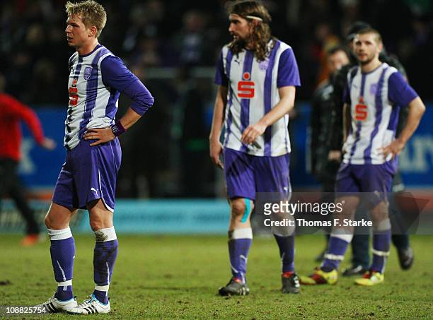 Kevin Schoeneberg, Jan Tauer and Sebastian Tyrala of Osnabrueck stand dejected on the pitch after the Second Bundesliga match between VfL Osnabrueck...