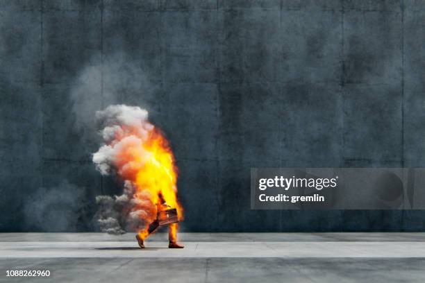 businessman in flames walking on the street - burning city stock pictures, royalty-free photos & images