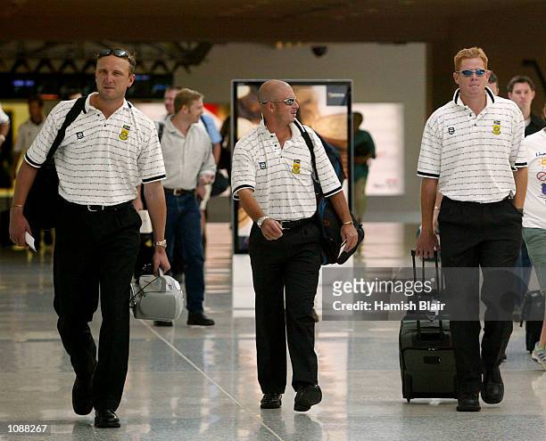 Allan Donald, Herschelle Gibbs and Shaun Pollock of South Africa walk to the plane, as the South Africans fly to Sydney for the second VB Series...