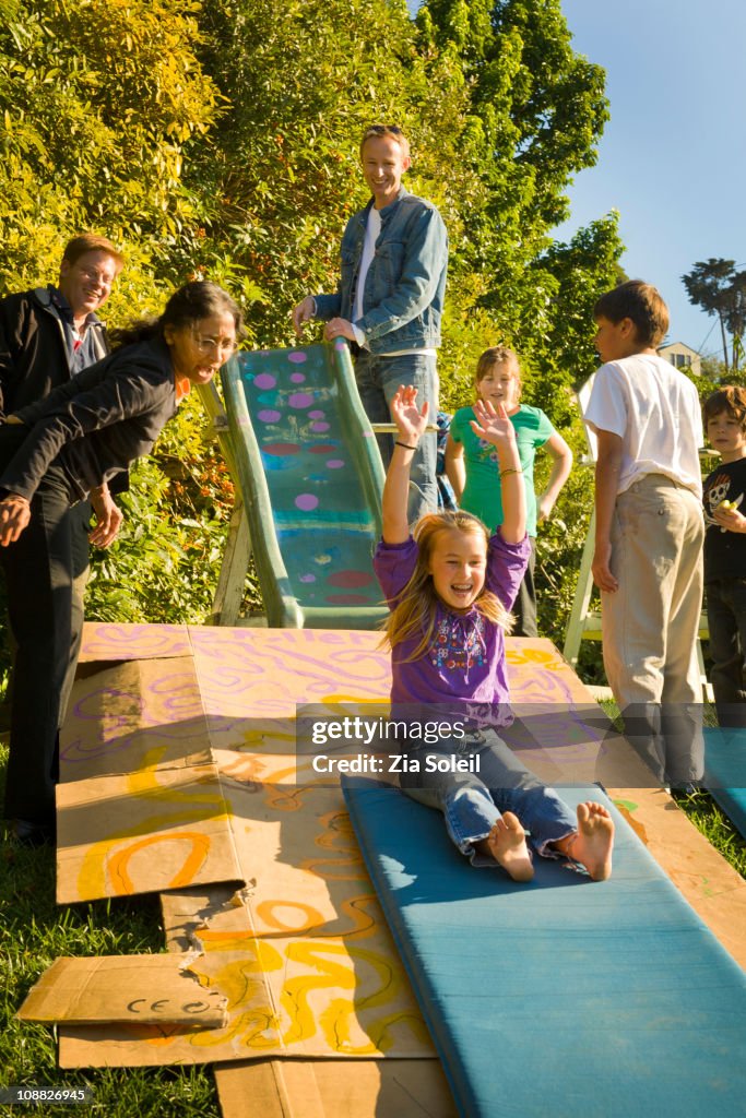 Makeshift backyard family sliding and play