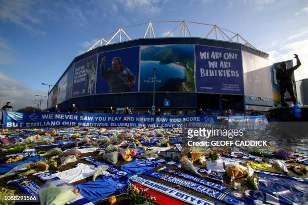 Cardiff City scarves and jerseys, flowers, messages and other tributes to the football club's new signing Emiliano Sala, whose flight disappeared...