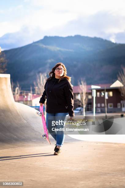 Young Adult Hispanic Woman Skateboarding