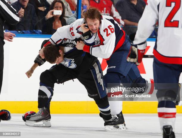 Matt Hendricks of the Washington Capitals fights Steve Downie of the Tampa Bay Lightning during the first period at the St. Pete Times Forum on...
