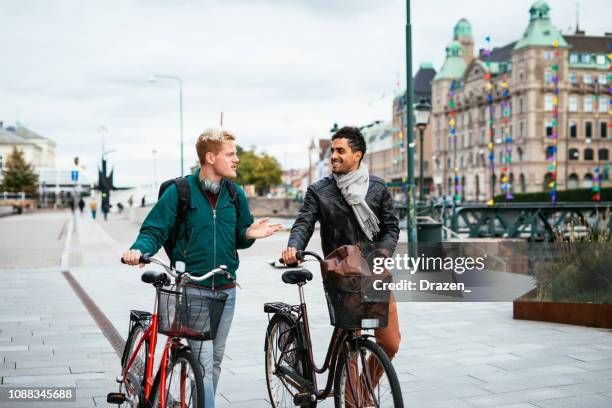 lgbt couple traveling around together - latino and scandinavian gay men enjoying their common life together - malmo stock pictures, royalty-free photos & images