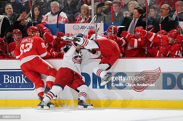 Marc Methot and Rick Nash of the Columbus Blue Jackets take each other out trying to hit Johan Franzen of the Detroit Red Wings in a game on February...