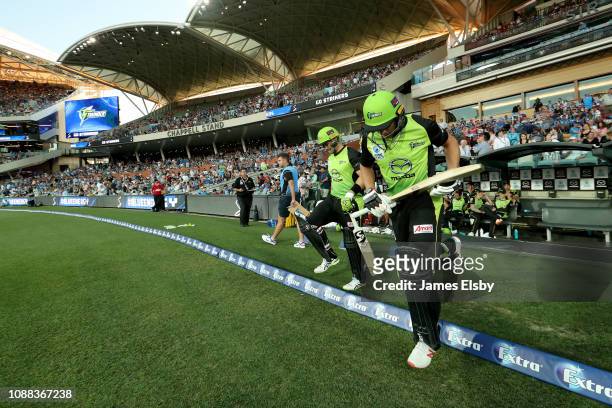 Shane Watson and Jos Buttler of the Thunder enter the field during the Big Bash League match between the Adelaide Strikers and the Sydney Thunder at...