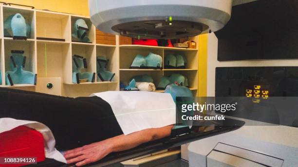 person receiving radiation therapy for cancer treatment in linear acelerator - lymphoma stock pictures, royalty-free photos & images
