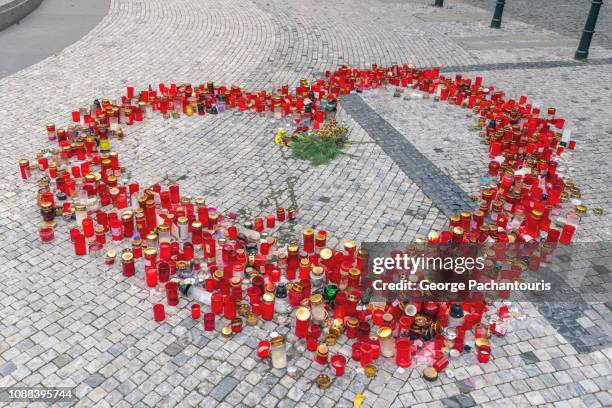 red candles laid in heart shape - trauerzeit stock-fotos und bilder