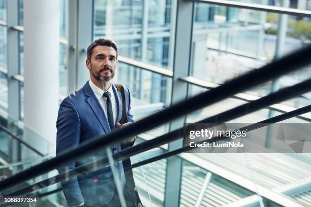 making business his mission - escalator stock pictures, royalty-free photos & images