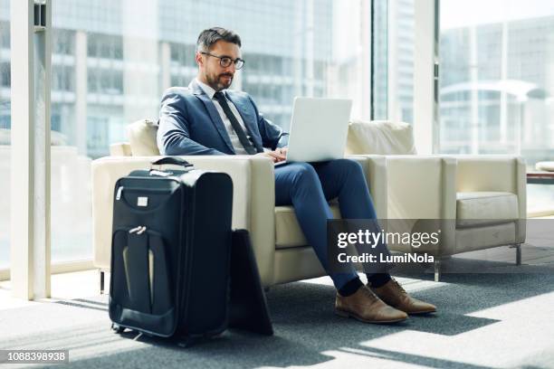 last minute work before he boards - businessman working stock pictures, royalty-free photos & images