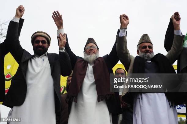 Munawar Hasan, chief of Jammat-e-Islami Pakistan raises hands with party leaders during the Kashmir Solidarity Day rally in Islamabad on February 5,...