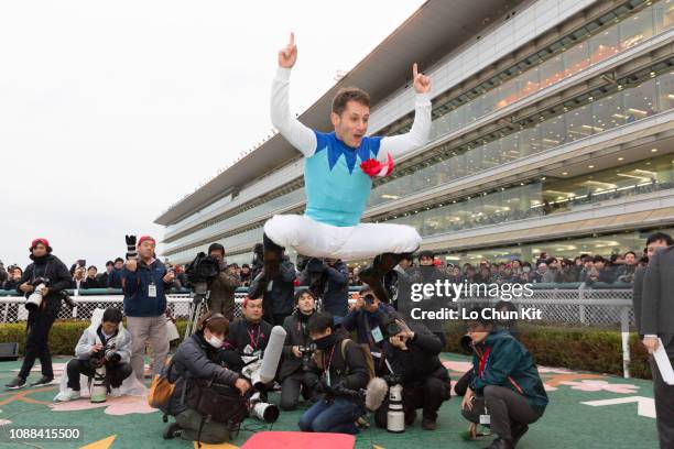 Jockey Mirco Demuro celebrates after Admire Mars winning the Race 11 Asahi Hai Futurity Stakes at Hanshin Racecourse on December 16, 2018 in...