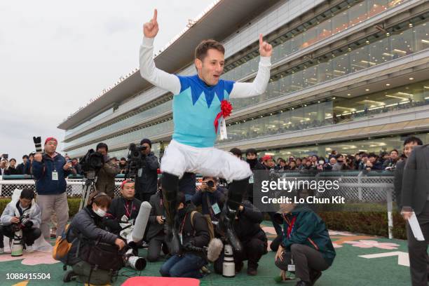 Jockey Mirco Demuro celebrates after Admire Mars winning the Race 11 Asahi Hai Futurity Stakes at Hanshin Racecourse on December 16, 2018 in...