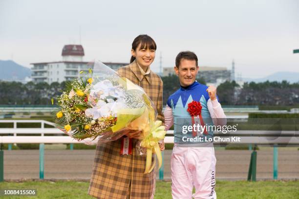 Jockey Mirco Demuro with idol Marie Iitoyo celebrate after Admire Mars winning the Race 11 Asahi Hai Futurity Stakes at Hanshin Racecourse on...