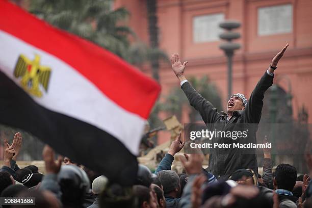 An anti-government protester chants and gestures in front of soldiers guarding the Egyptian Museum in Tahrir Square on February 5, 2011 in Cairo,...