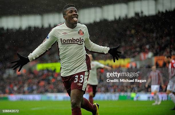 Asamoah Gyan of Sunderland celebrates scoring to make it 2-1 during the Barclays Premier League match between Stoke City and Sunderland at the...