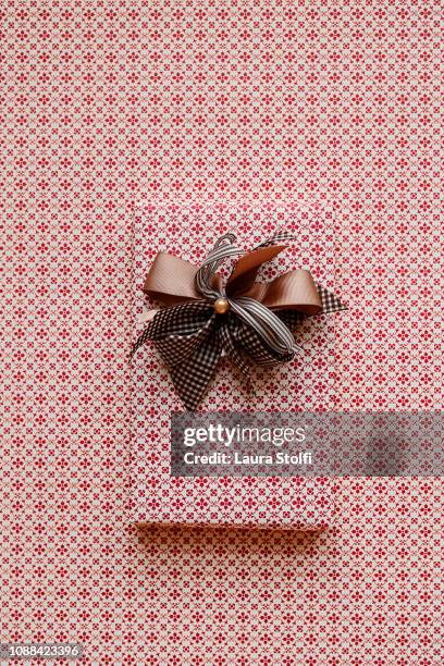 tiny patterned gift with ribbon and pearl - satin paper stock pictures, royalty-free photos & images