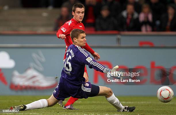 Christian Clemens of Koeln scores his teams first goal past goalkeeper Thomas Kraft of Muenchen during the Bundesliga match between 1. FC Koeln and...