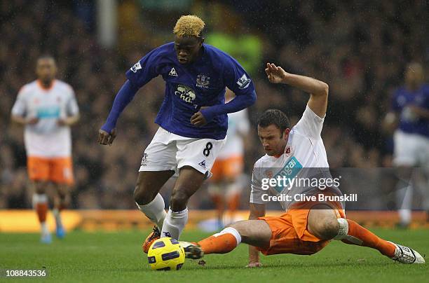 Louis Saha of Everton is tackled by Ian Evatt of Blackpool during the Barclays Premier League match between Everton and Blackpool at Goodison Park on...