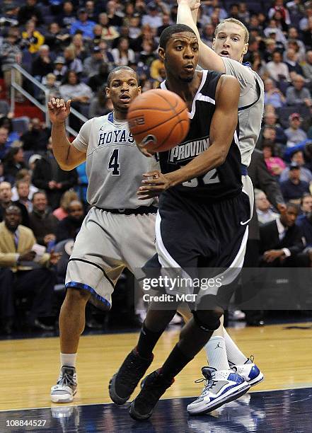 Providence guard Vincent Council dishes the ball off while under pressure from Georgetown guard Chris Wright and forward Nate Lubick during...