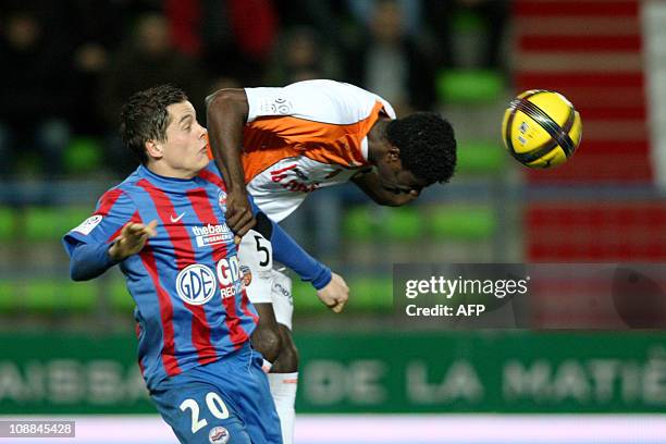 Lorient's Gabonese defender Bruno Ecuele Manga vies with Caen French midfielder Romain Hamouma during the French L1 football match Caen vs Lorient on...