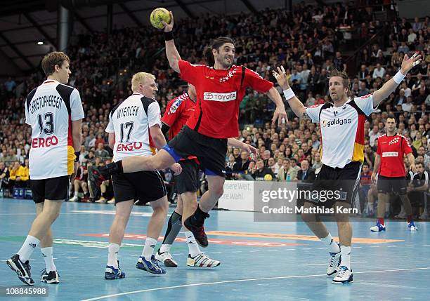 Bertrand Gille of All Star Team throws during a friendly game between Germany and the Handball Bundesliga Allstars at Arena on February 5, 2011 in...