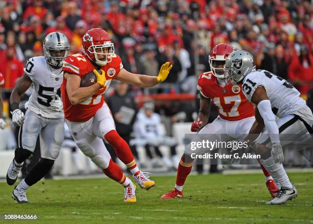 Tight end Travis Kelce of the Kansas City Chiefs runs up field after catching a pass during the first half against strong safety Marcus Gilchrist of...