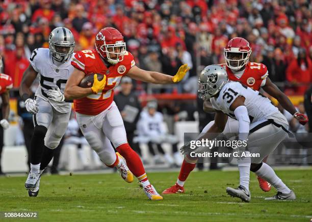 Tight end Travis Kelce of the Kansas City Chiefs runs up field after catching a pass during the first half against strong safety Marcus Gilchrist of...