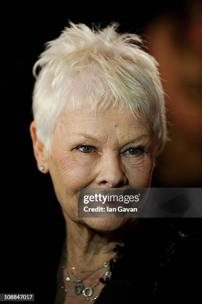 The Dorchester Outstanding Achievement Award winner Dame Judi Dench poses in the press room at the South Bank Sky Arts Awards at The Dorchester on...