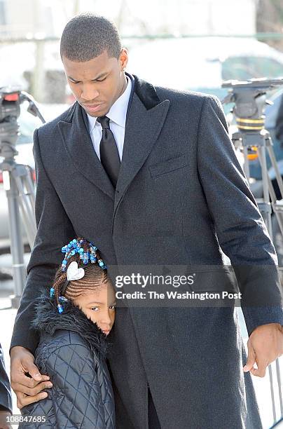January 27 : Universirty of Kansas forward Thomas Robinson comforts his little sister, Jayla as they arrive for the funeral for their mother Lisa...