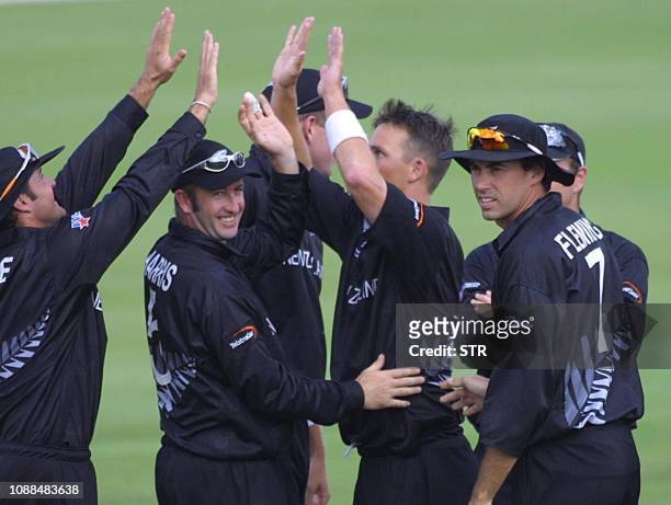 The New Zealand team with Chris Harris celebrate after Shane Bond toke the wicket of India's Captain, Sourav Ganguly for 3 runs in the ICC Cricket...