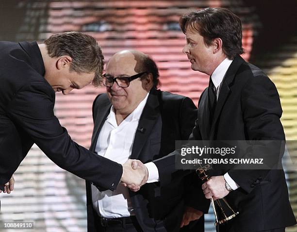 Canadian actor Michael J. Fox shakes hands with German tv host Hape Kerkeling after he was given his international lifetime achievement award by US...