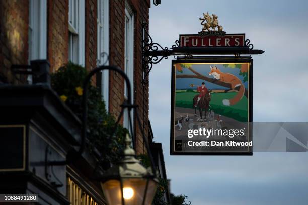 Sign hangs outside the Fox and Hounds pub next to Fuller Smith & Turner in Chiswick on January 25, 2019 in London, England. The 175 year old family...