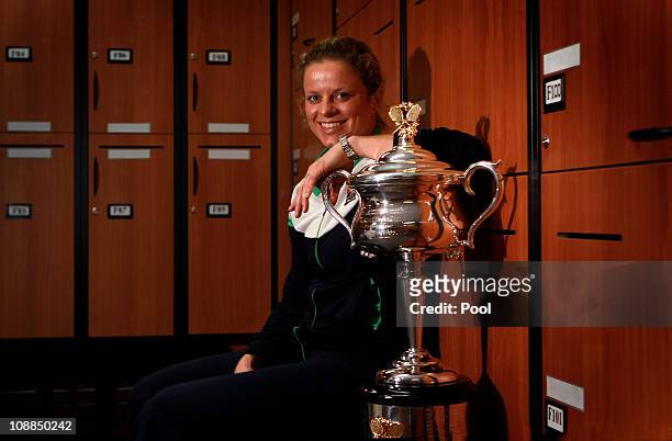 Kim Clijsters of Belgium poses with the Daphne Akhurst Trophy in the changing room after winning her women's final match against Na Li of China...