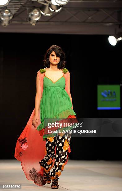 Pakistani model presents a creation by Pakistani designer Hameeda during first day of Islamabad Fashion Week in Islamabad on January 27, 2011. Some...