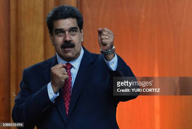 Venezuelan President Nicolas Maduro leaves after offering a press conference in Caracas, on January 25, 2019. - Venezuela's opposition leader Juan...