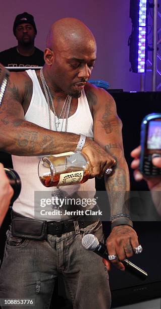 Treach of Naughty By Nature pours a tribute shot of Hennessy on his tatoo of Tupac Shakur during a performance at the Big Game Old School Kickoff...