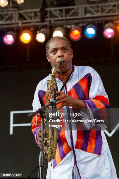Nigerian Afrobeat musician Femi Kuti plays saxophone as he performs with his band, Positive Force, at Central Park SummerStage, New York, New York,...