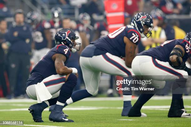 Deshaun Watson of the Houston Texans kneels prior to a snap in the first quarter against the Jacksonville Jaguars at NRG Stadium on December 30, 2018...