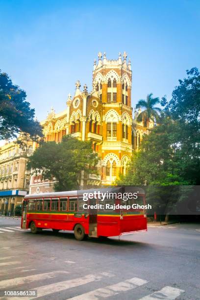 mumbai bus and colonial building - mumbai street stock pictures, royalty-free photos & images