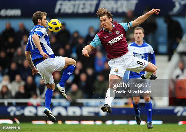 David Bentley of Birmingham City and Scott Parker of West Ham United battle for control of the ball during the Barclays Premier League match between...