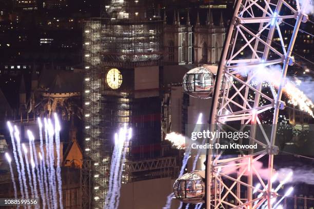 Fireworks explode over The London Eye and Elizabeth Tower near Parliament as thousands of revelers gather along the banks of the River Thames to ring...