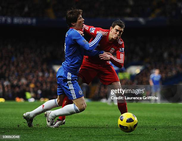 Fernando Torres of Chelsea is challenged by Daniel Agger of Liverpool during the Barclays Premier League match between Chelsea and Liverpool at...