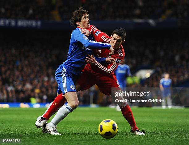 Fernando Torres of Chelsea is challenged by Daniel Agger of Liverpool during the Barclays Premier League match between Chelsea and Liverpool at...