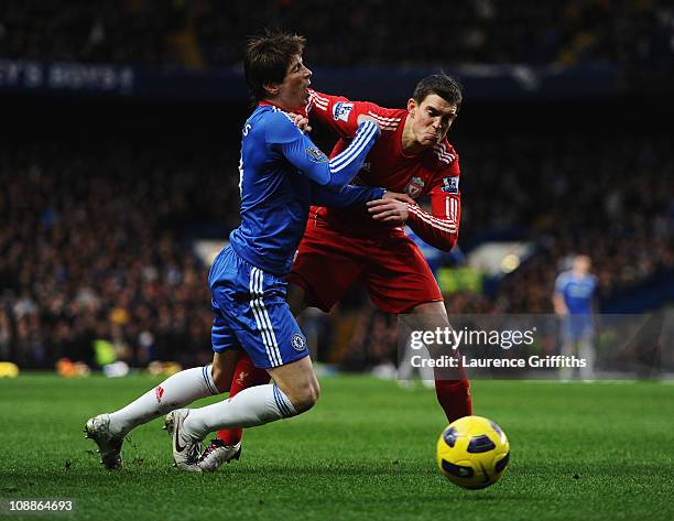 Fernando Torres of Chelsea is challenged by Daniel Agger of Liverpool during the Barclays Premier League match between Chelsea and Liverpool at...