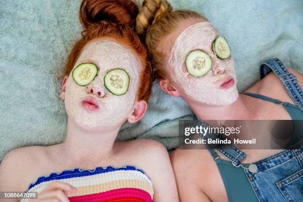 teenages check out their skin for pimples and apply face masks - low self esteem stock pictures, royalty-free photos & images